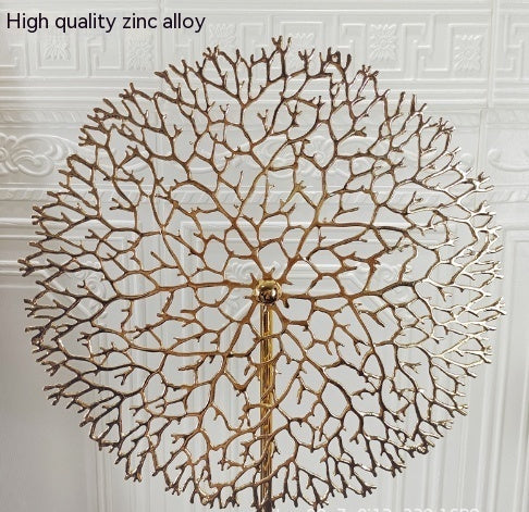 Decorative wall clock with a leaf-like design on a textured wall. - Lioré® USA