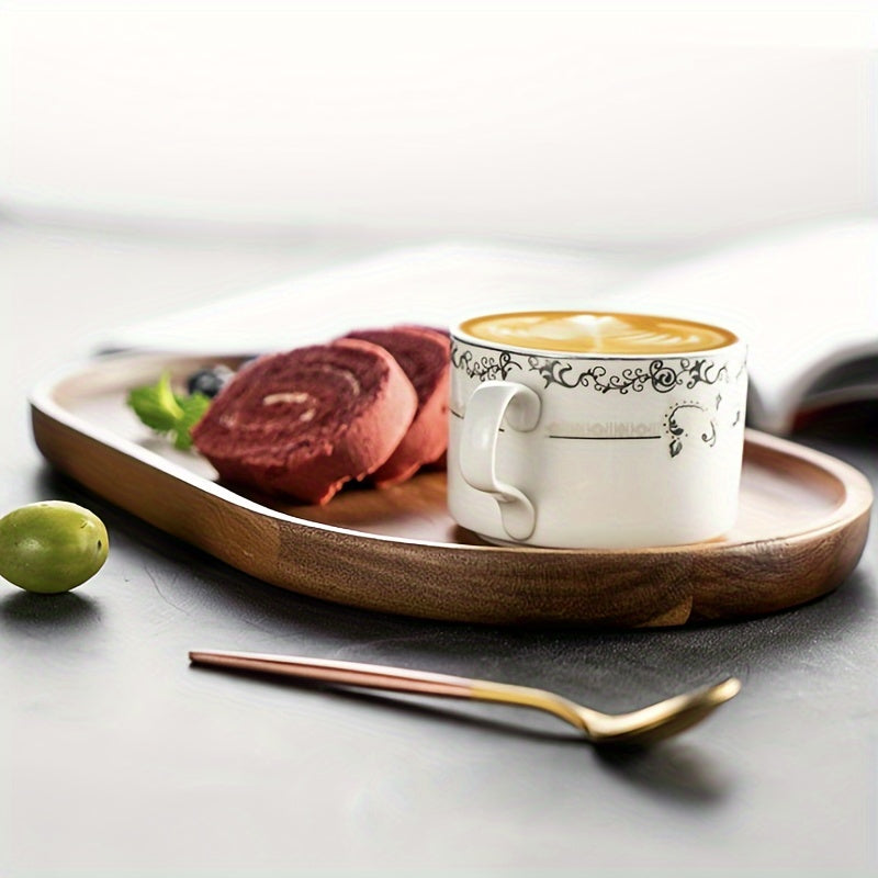 Cup of coffee with decorative patterns on a wooden tray with pastries and a spoon. - Lioré®