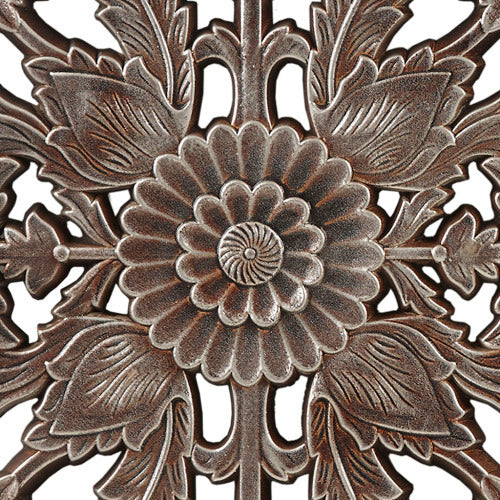 Decorative metal wall art closeup with floral design on a white background - Lioré® USA