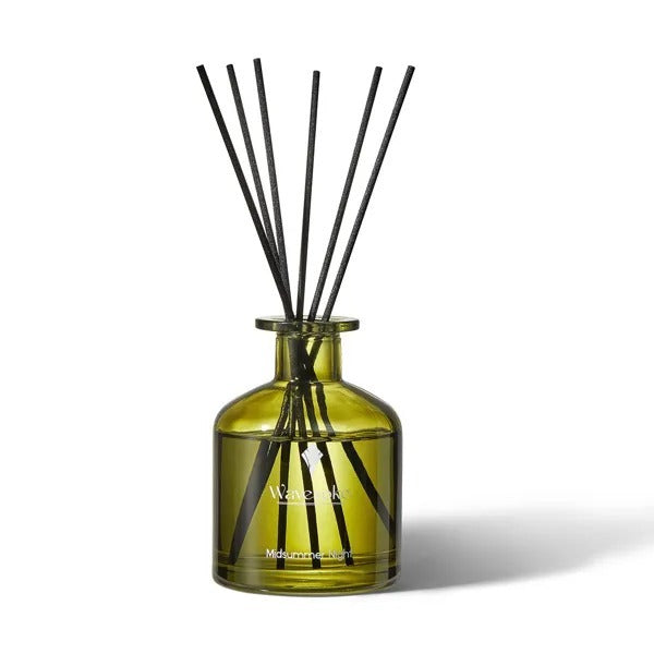 Green diffuser bottle with black sticks on a white background - Lioré®