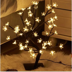 Decorative LED tree with illuminated branches on a soft surface - Lioré® USA