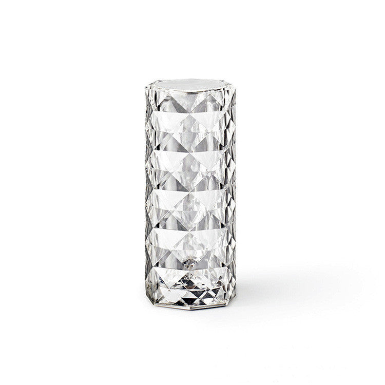 Clear glass LED lamp with diamond-cut pattern on a white background - Lioré® USA