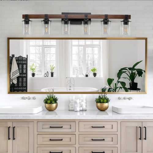 Bathroom vanity with large mirror, lights, and decorative elements. - Lioré® USA