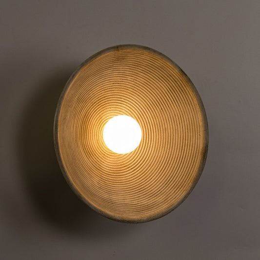 Round wooden light fixture with a warm glow on a dark background - Lioré® USA