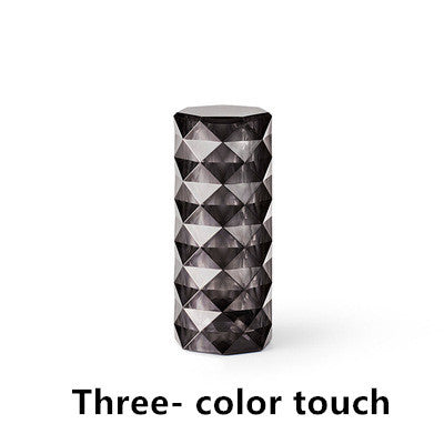 Tall cylindrical LED lamp with geometric pattern on a white background - Lioré® USA