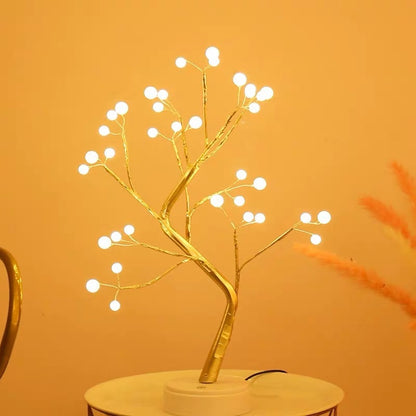 Decorative LED tree with white lights on a gold branch against an orange background - Lioré® USA