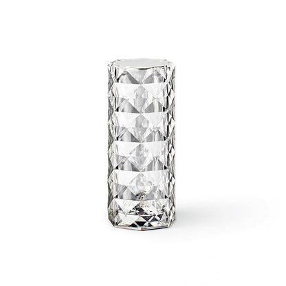 Clear glass LED lamp with diamond-cut pattern on a white background - Lioré® USA